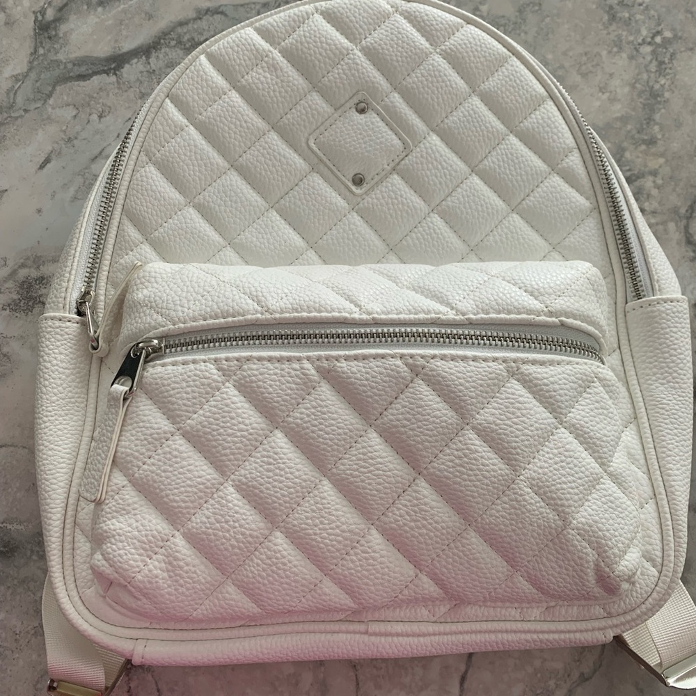 NWT. Icing white faux leather backpack. Approximate dimensions 12x13 inches.